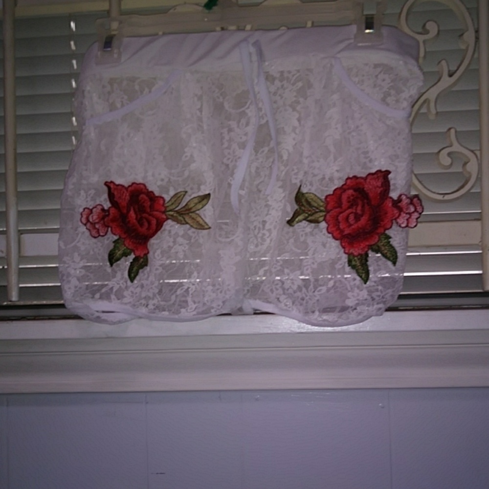 White lace shorts with red flowers on them